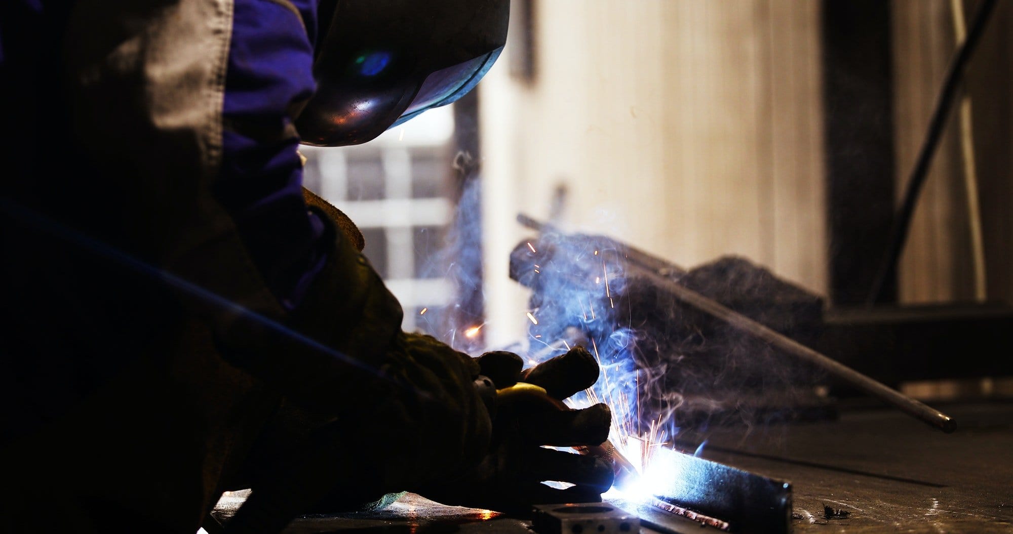 Metal worker welding in metal industry factory
