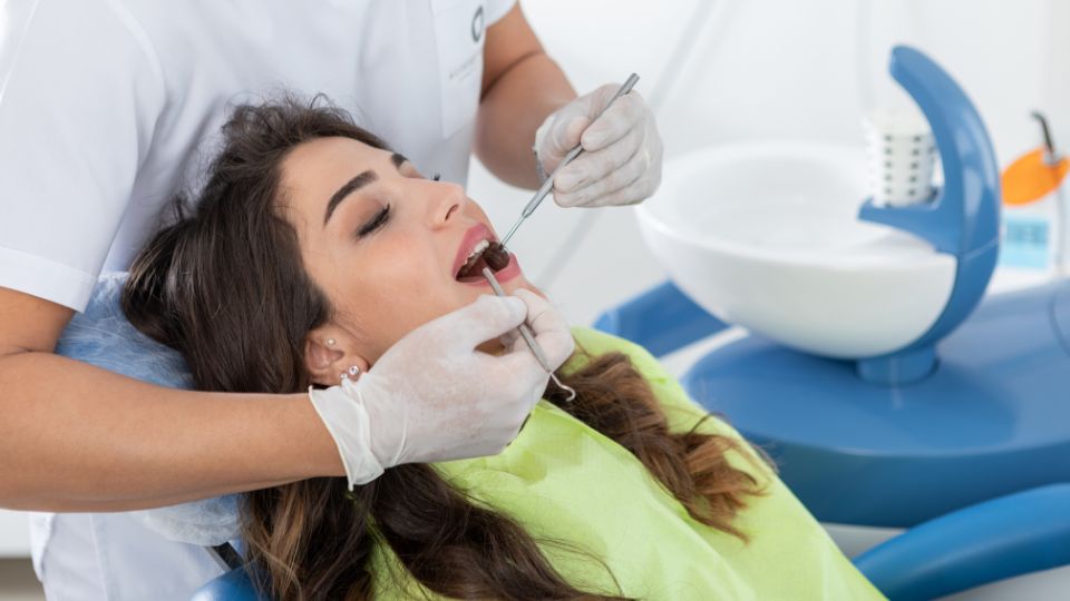 A Female Patient Receiving Dental Treatment