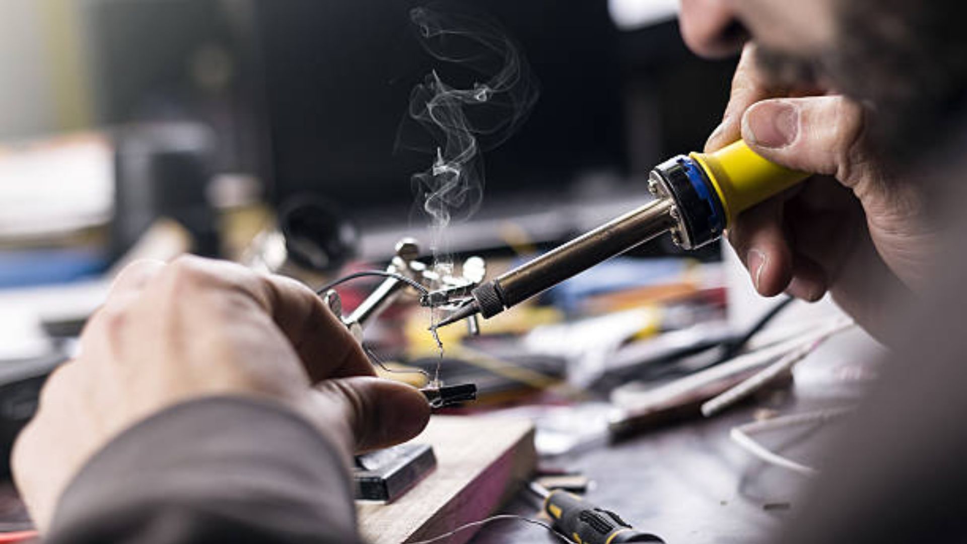 A Man Holding a Soldering Iron